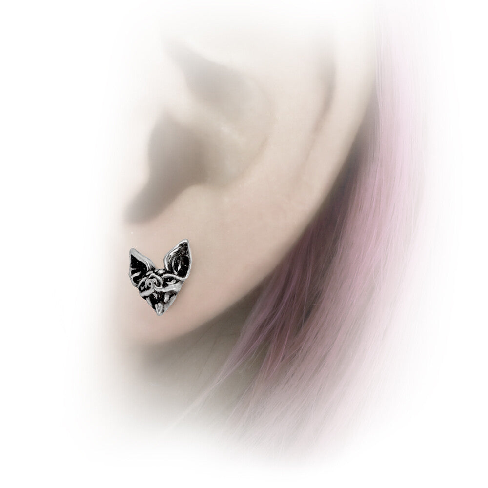 Earring worn on an ear with a blurred background