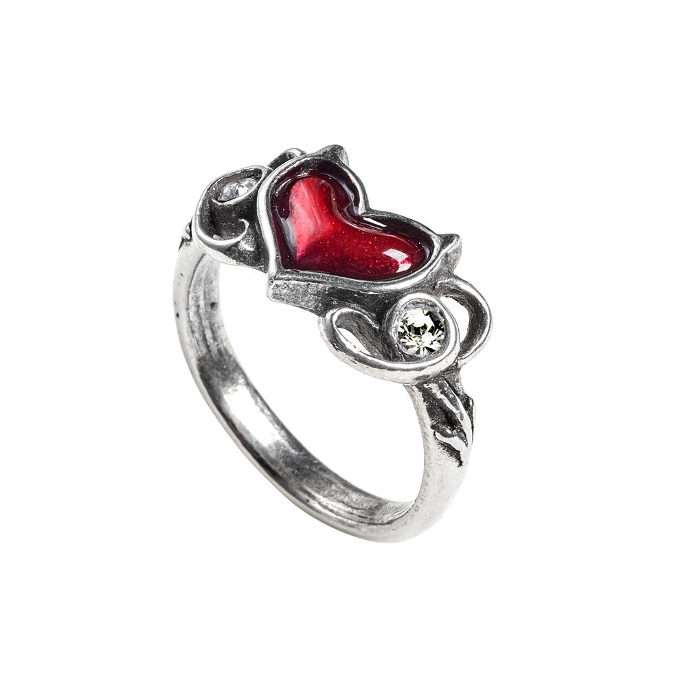 Silver ring with a red heart-shaped gem and clear stones on a white background