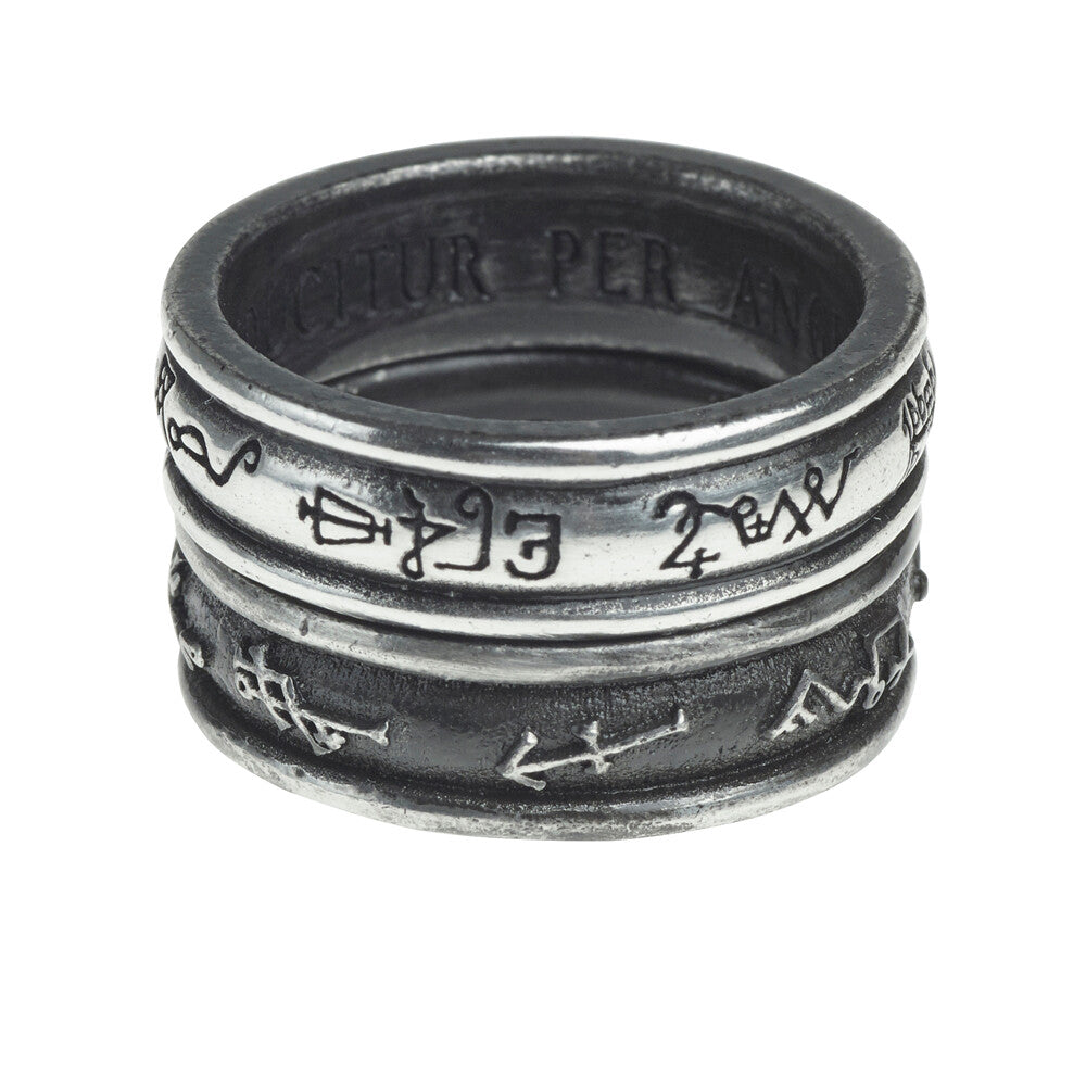 Silver ring with engraved symbols on a white background