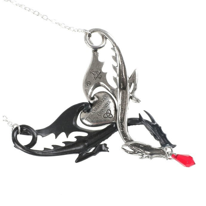 Metallic pendant with intricate designs on a white background