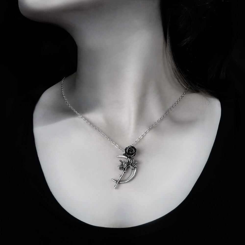 Silver necklace with a unique pendant on a mannequin neck against a black background