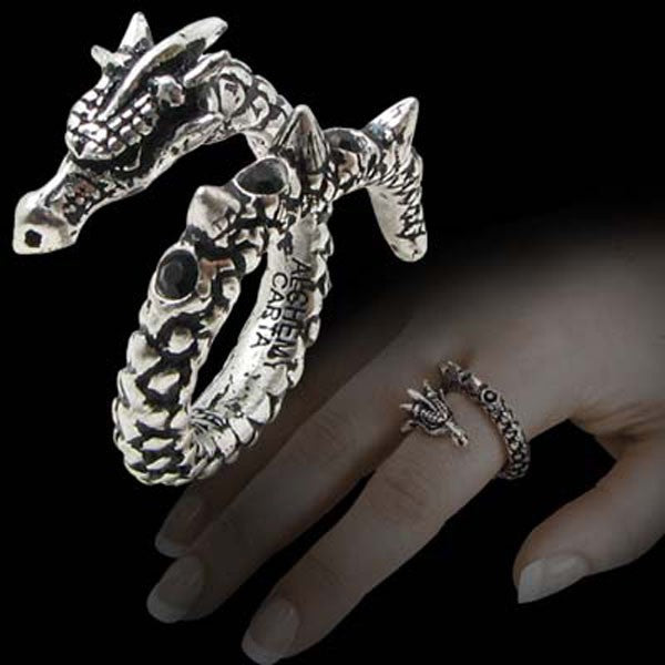 Silver dragon-shaped ring on a hand with a dark background