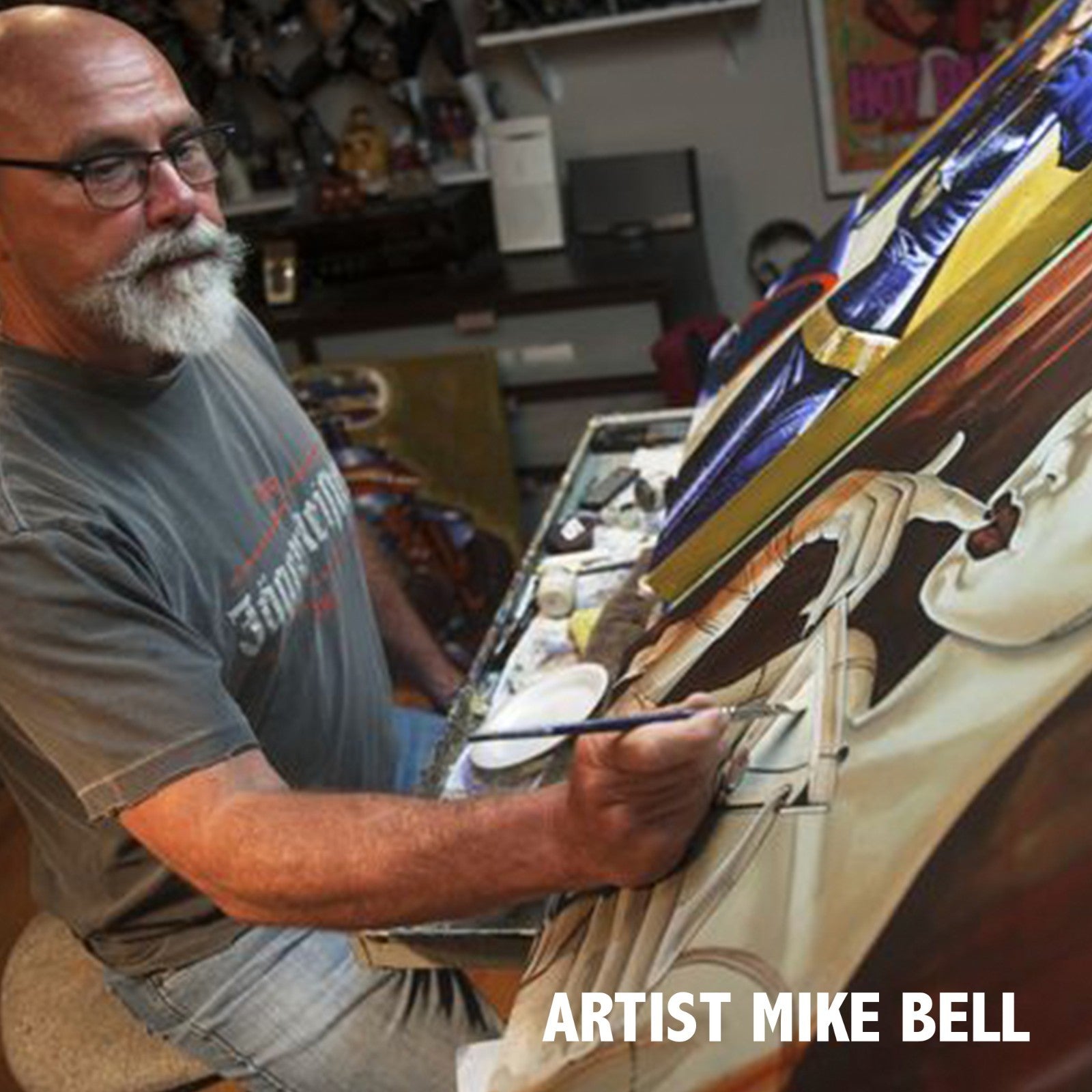 Artist Mike Bell working on a painting in his studio.