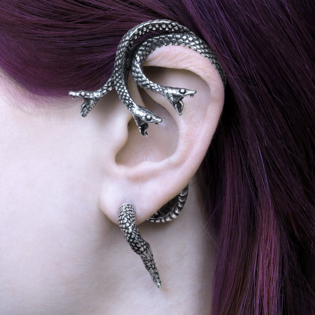 Silver dragon-shaped ear cuff worn by a person with purple hair.