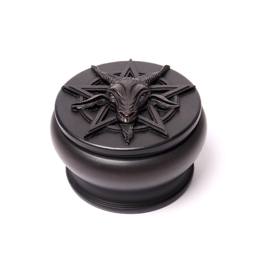 Black metal container with goat head and pentagram design on a white background