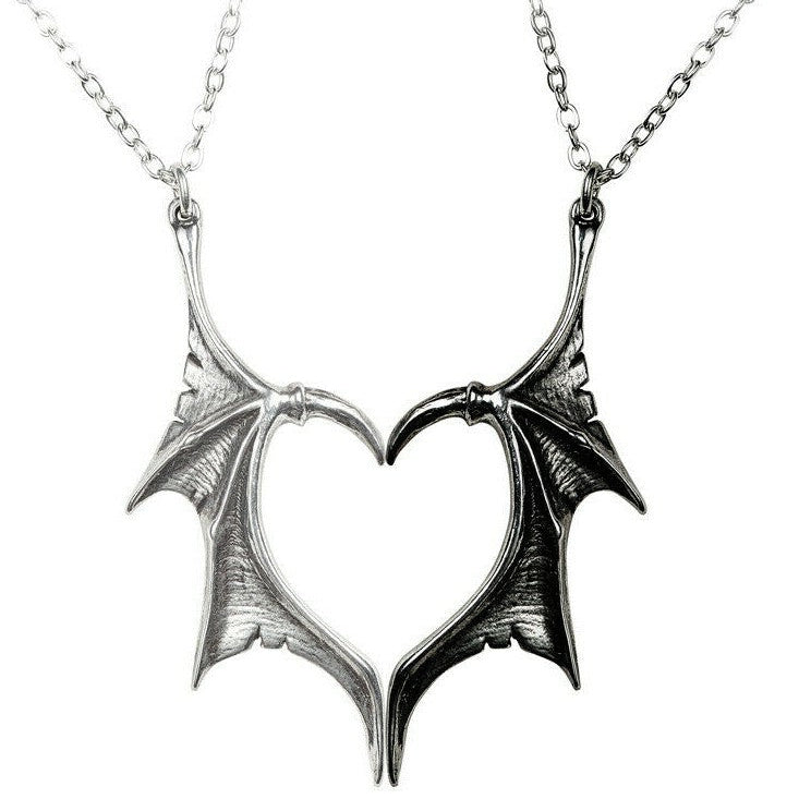 Pair of dragon wing pendants on a white background