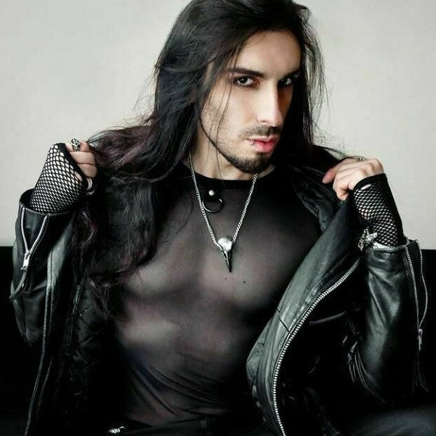 Person wearing a black leather jacket with fishnet gloves against a neutral background