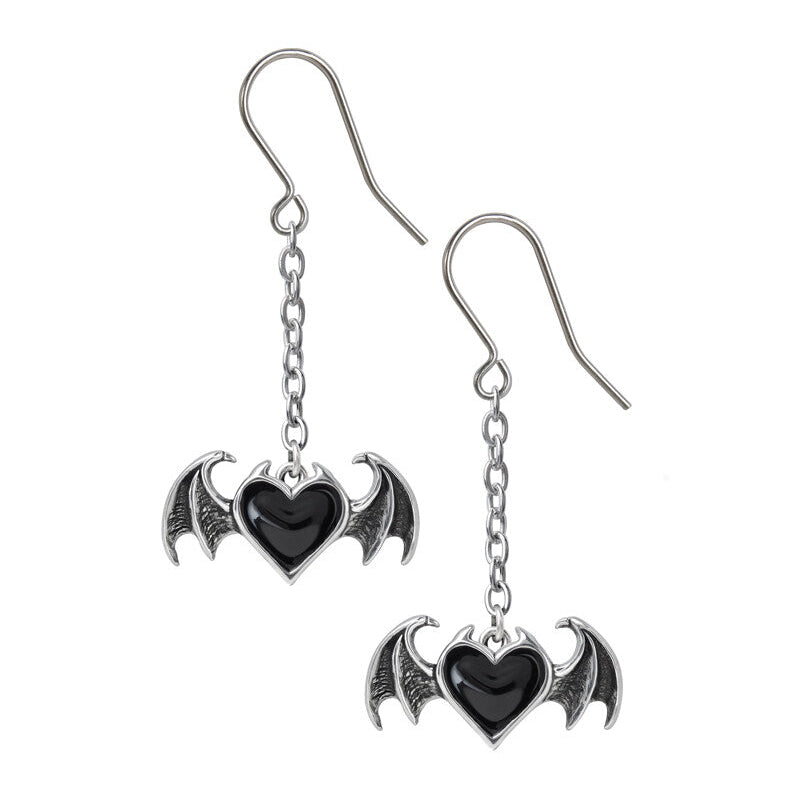 Pair of earrings with bat wings and heart design on a white background