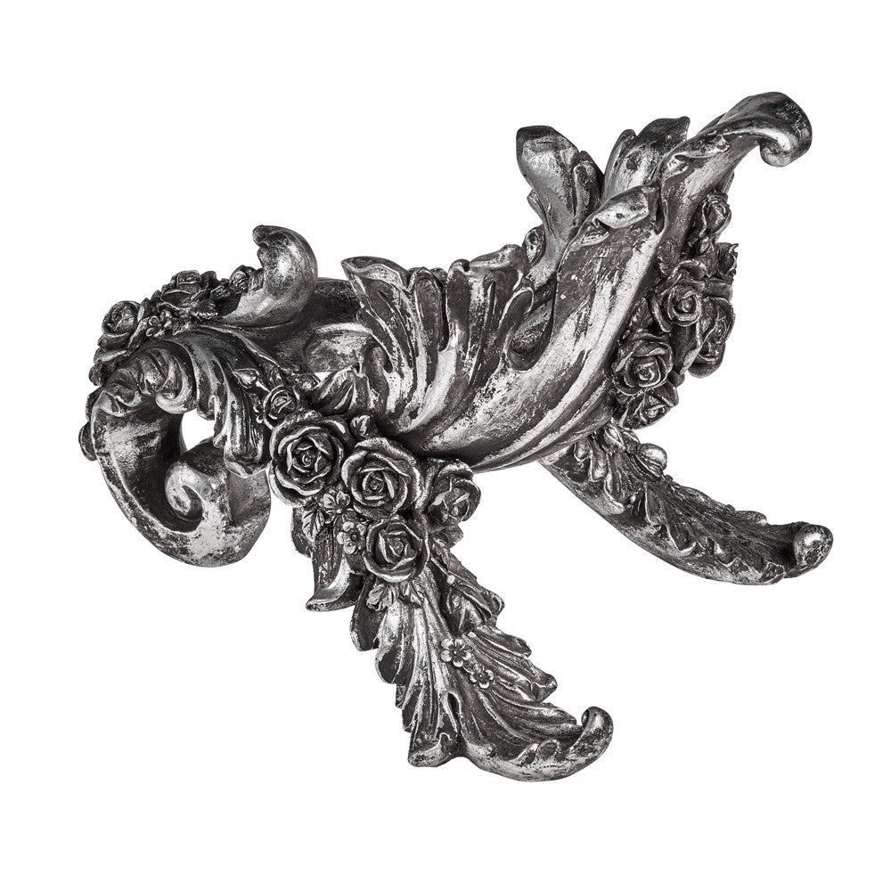 Decorative metal wall piece with floral and scroll design on a white background