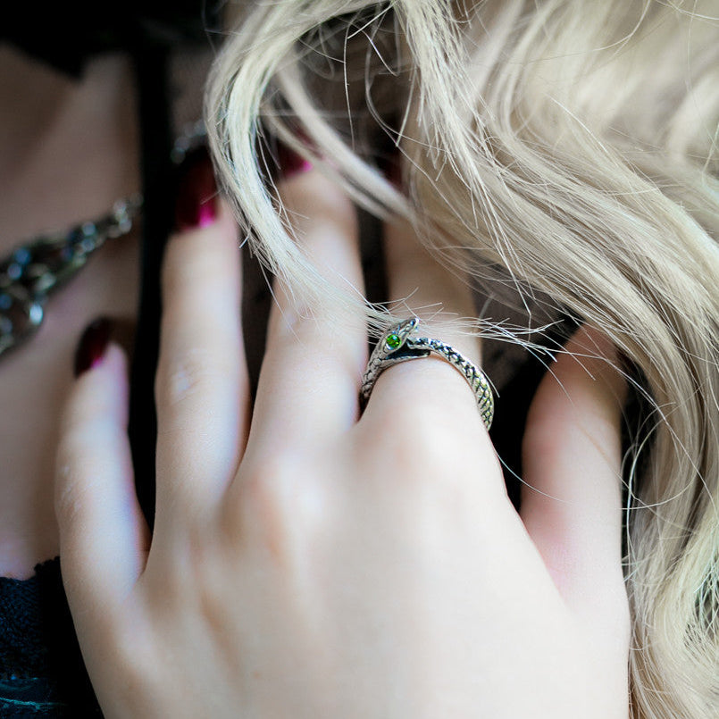 Close-up of a hand with a ring, blurred background