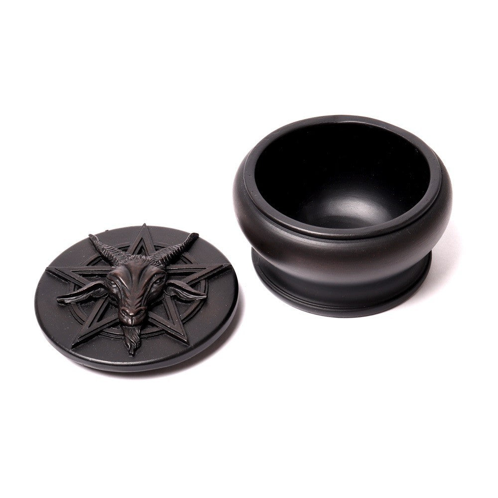 Black decorative container with goat head design on a white background