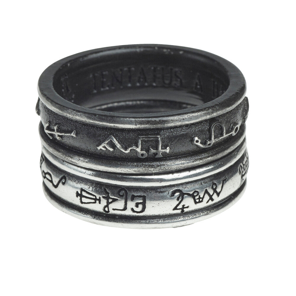 Silver ring with engraved symbols on a white background