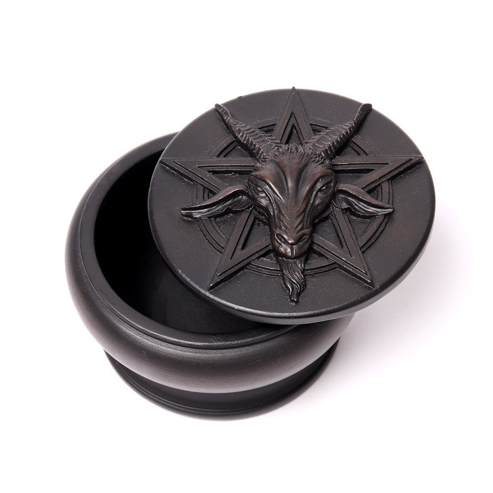 Black decorative box with goat head and star design on a white background