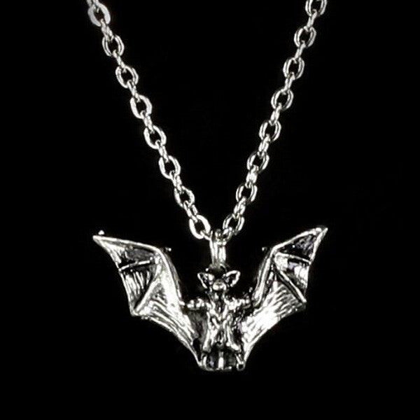 Silver bat pendant necklace on a black background