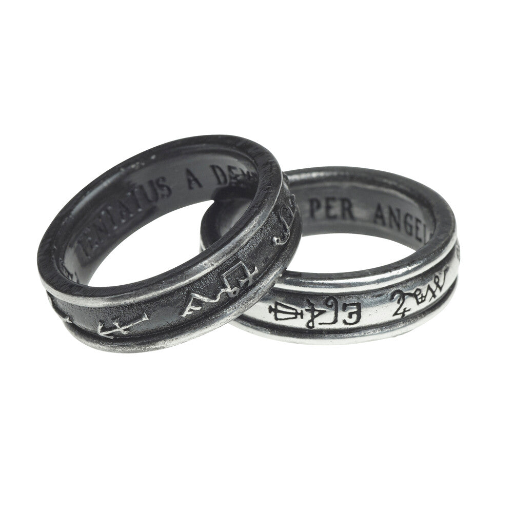 Two silver rings with engraved text on a white background