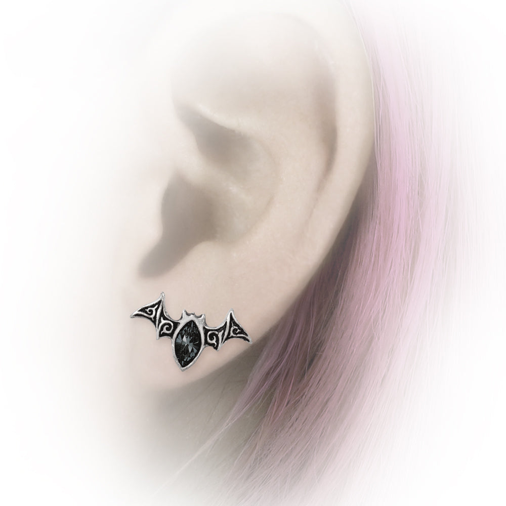 Earring worn on an ear with a blurred background
