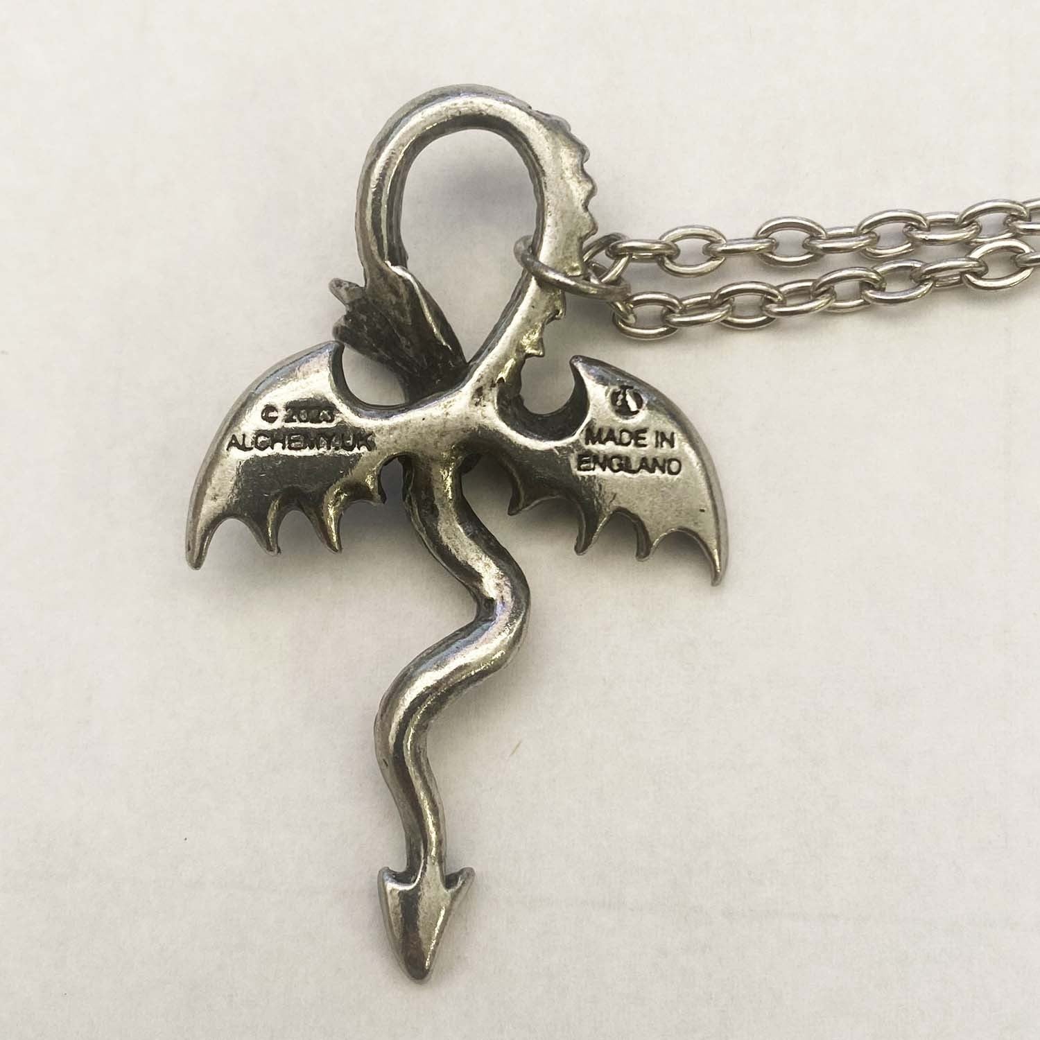 Silver dragon pendant on a chain with 'Made in England' stamp on a white background
