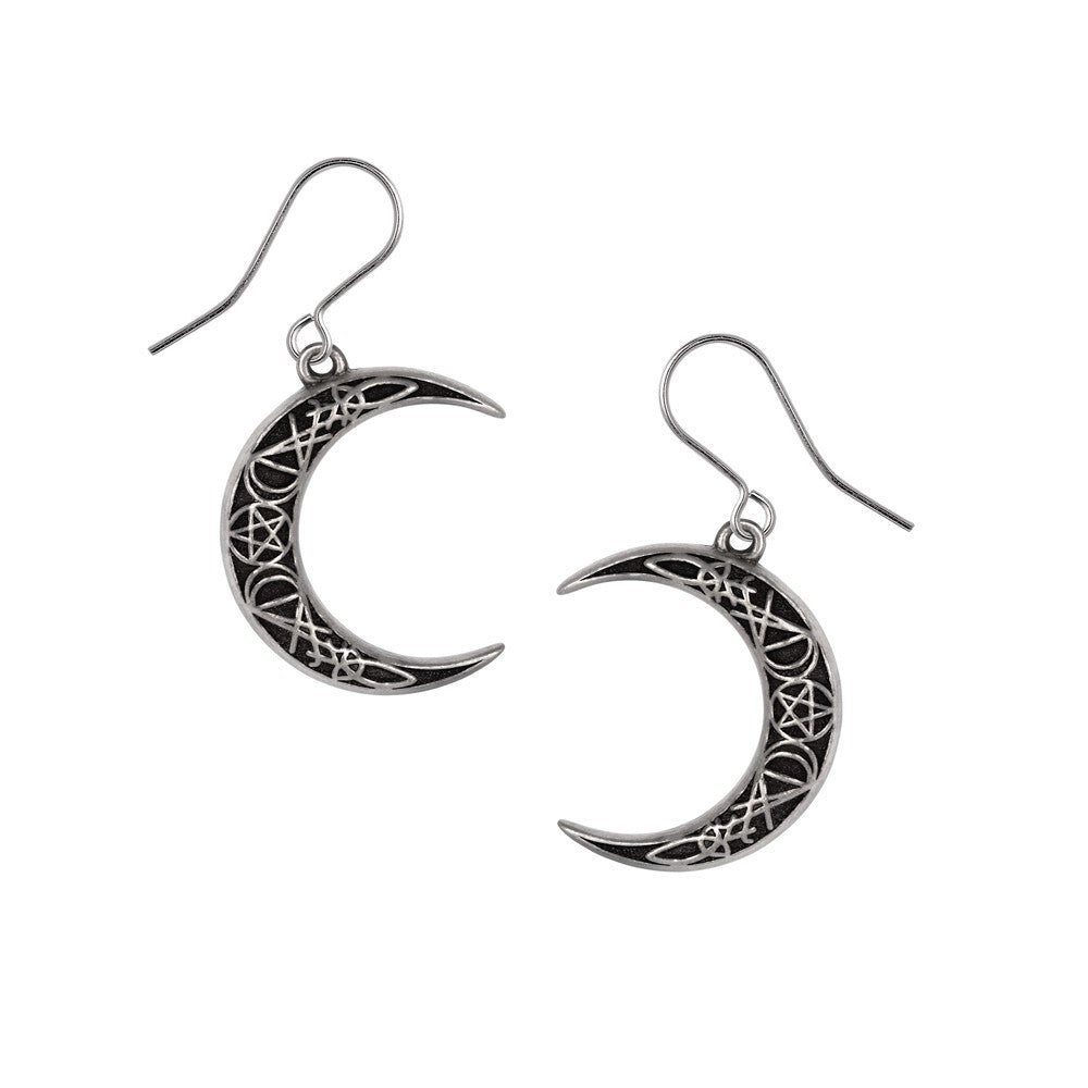 Silver crescent moon earrings with intricate designs on a white background