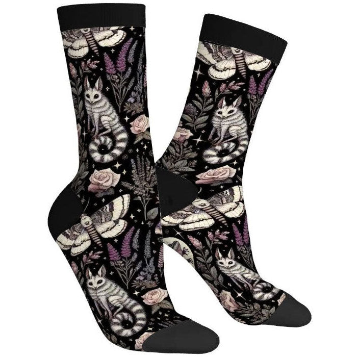 Pair of socks with cat and floral design on a white background