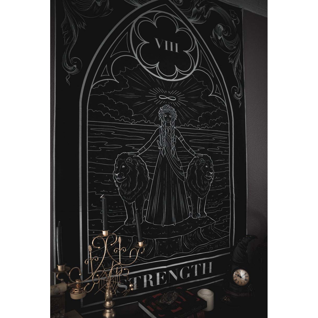 Decorative wall art with 'Strength' tarot card design, featuring a woman with lions on either side, in a dark frame.
