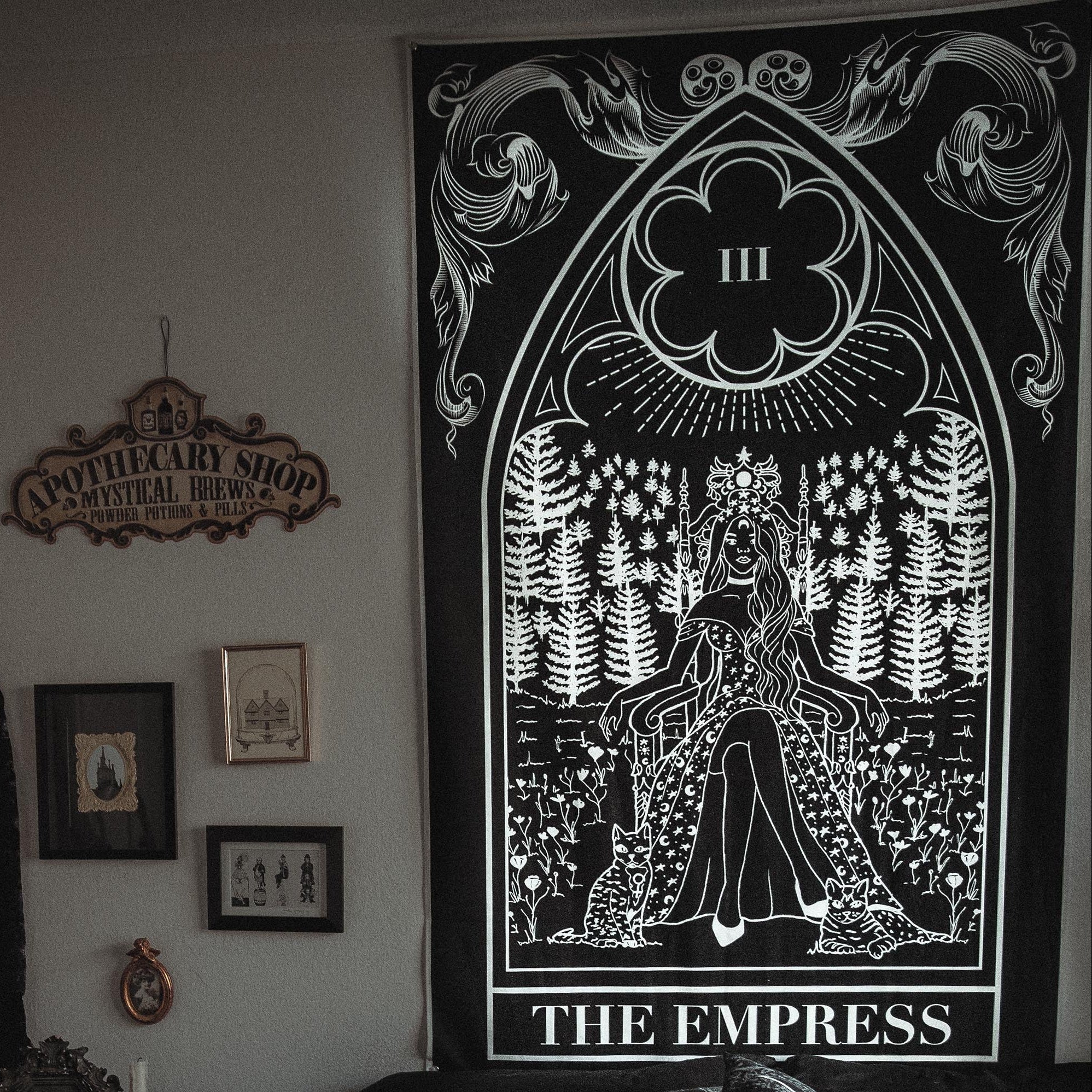 Living room with a large tapestry titled 'The Empress' on the wall.