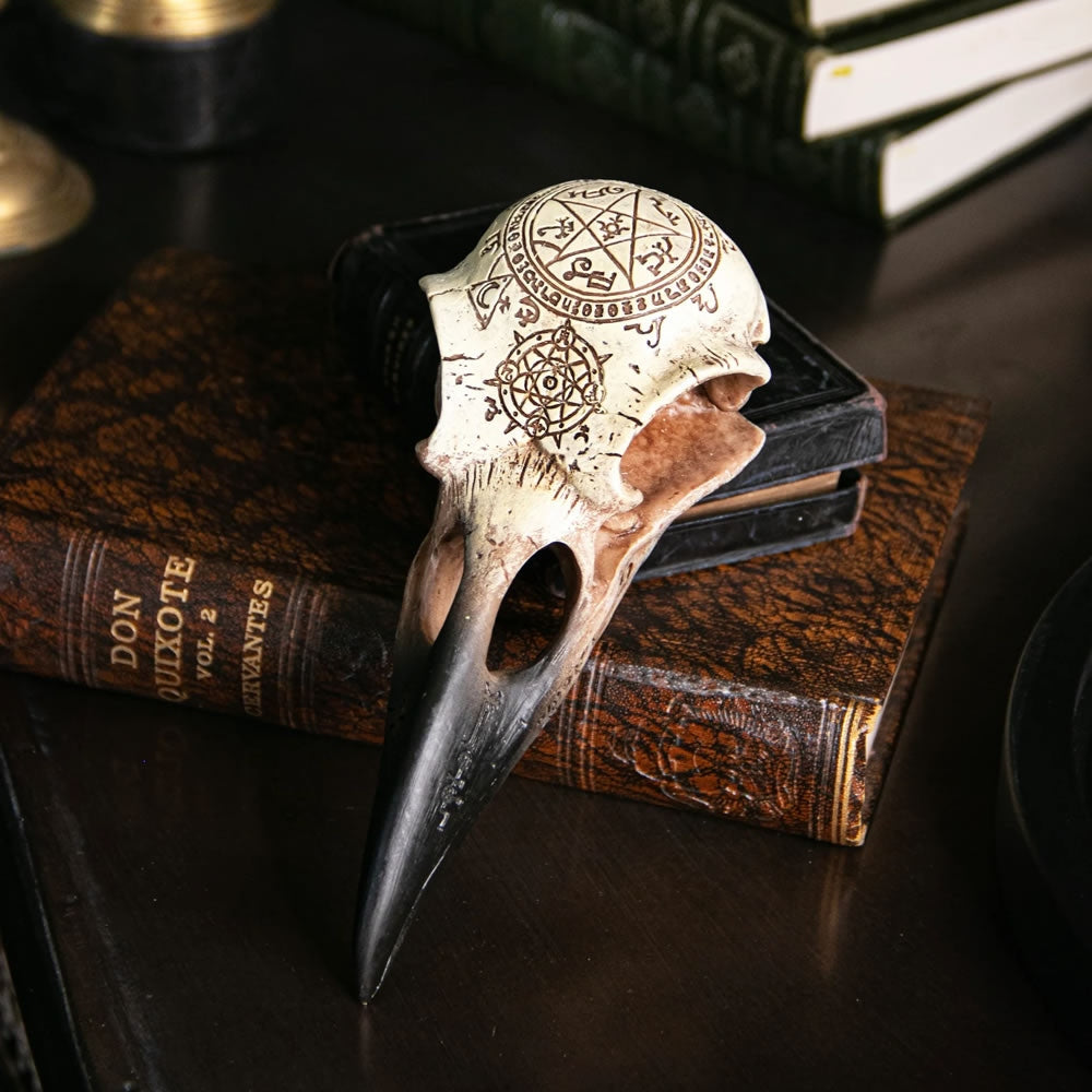Decorative bird skull with intricate carvings on a book